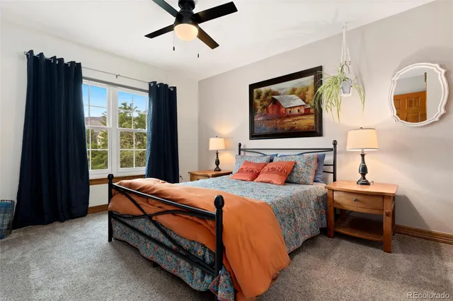 a bedroom with a bed and a painting on the wall