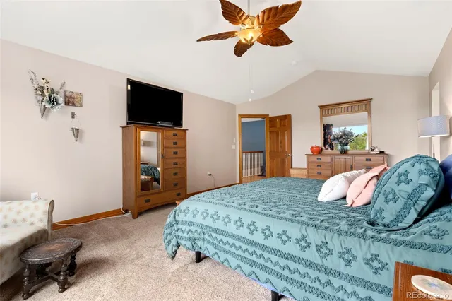 a bedroom with a large bed and a flat screen tv