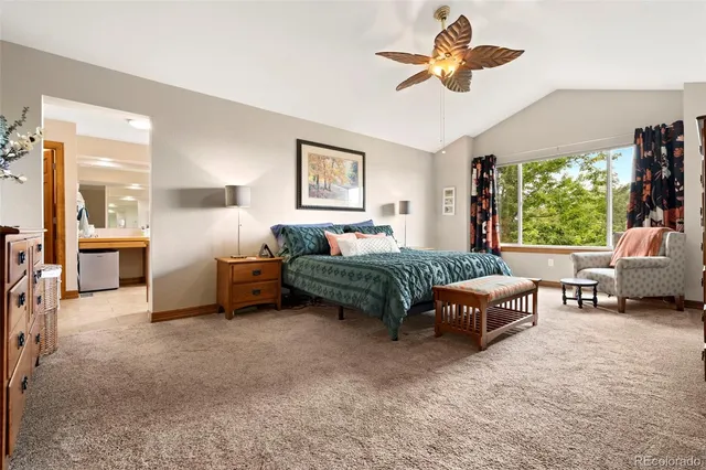 a bedroom with furniture and a large window