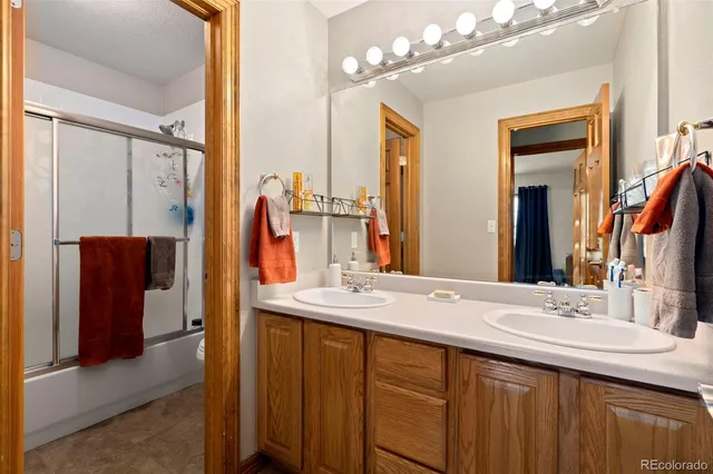 a bathroom with a double vanity sink and a mirror