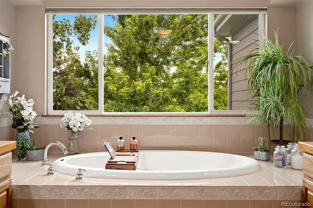 a bathroom with a granite countertop sink and a large mirror