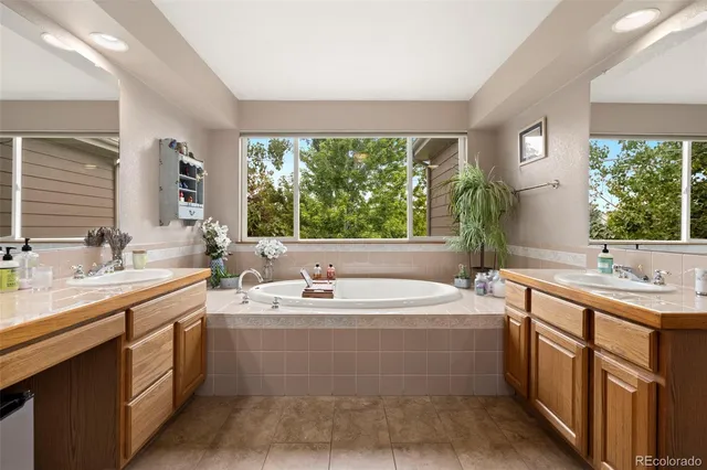 a bathroom with a double vanity sink and a bathtub
