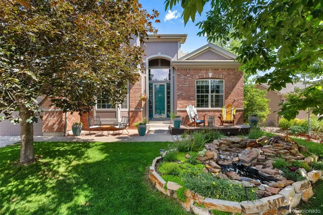 a front view of a house with a yard table and chairs