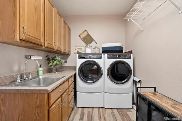 a utility room with sink dryer and washer