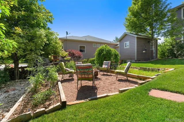 a view of a house with backyard and sitting area