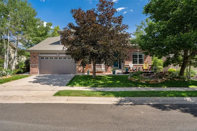 a backyard of a house with lots of green space and trees all around