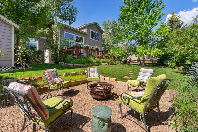 a view of a chairs and table in backyard of the house