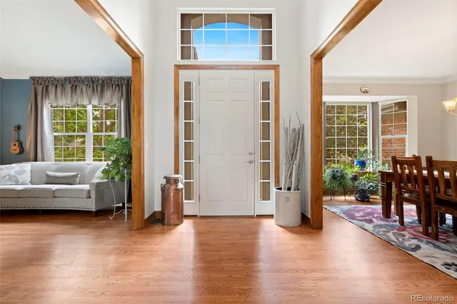 a living room with furniture and large windows