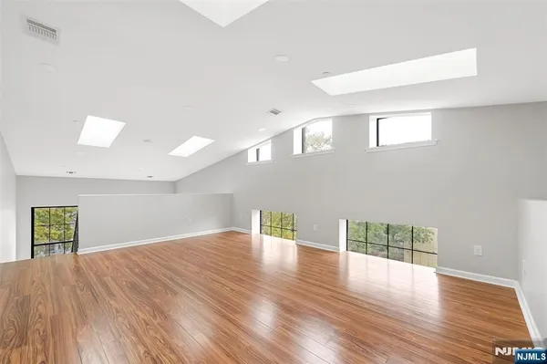 a view of empty room with wooden floor
