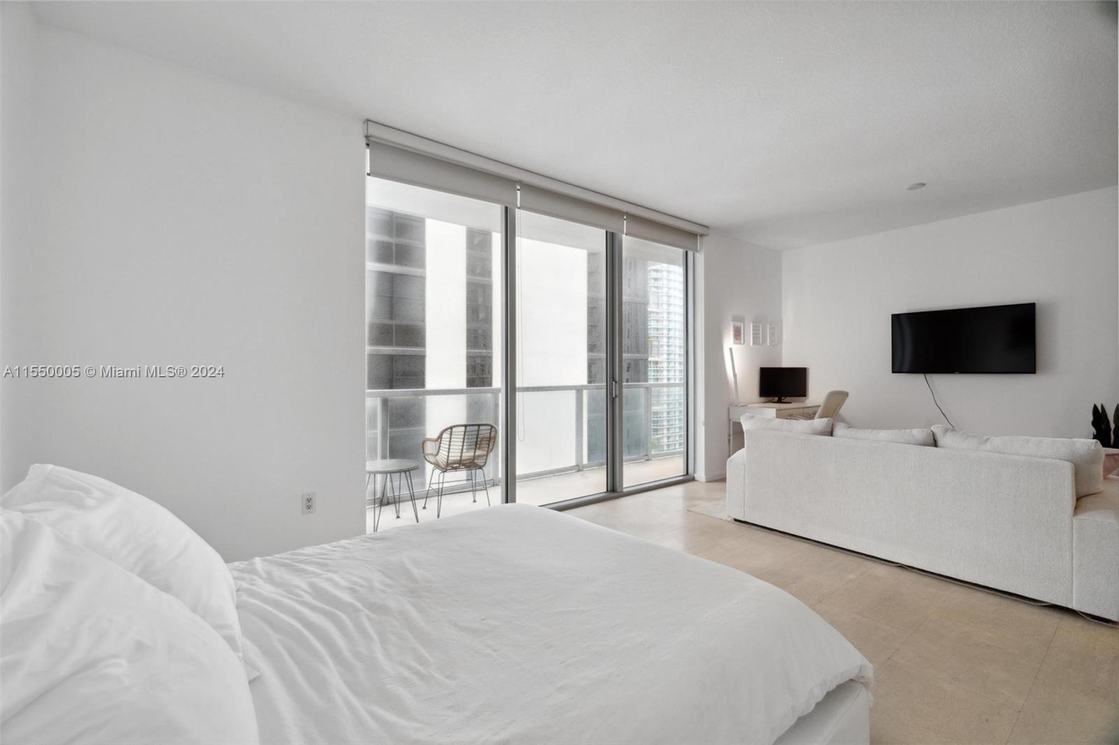 1050 Brickell Avenue, Unit 2422 Miami, FL 33131 - Photo 12 of 21 a bedroom with a bed and large window