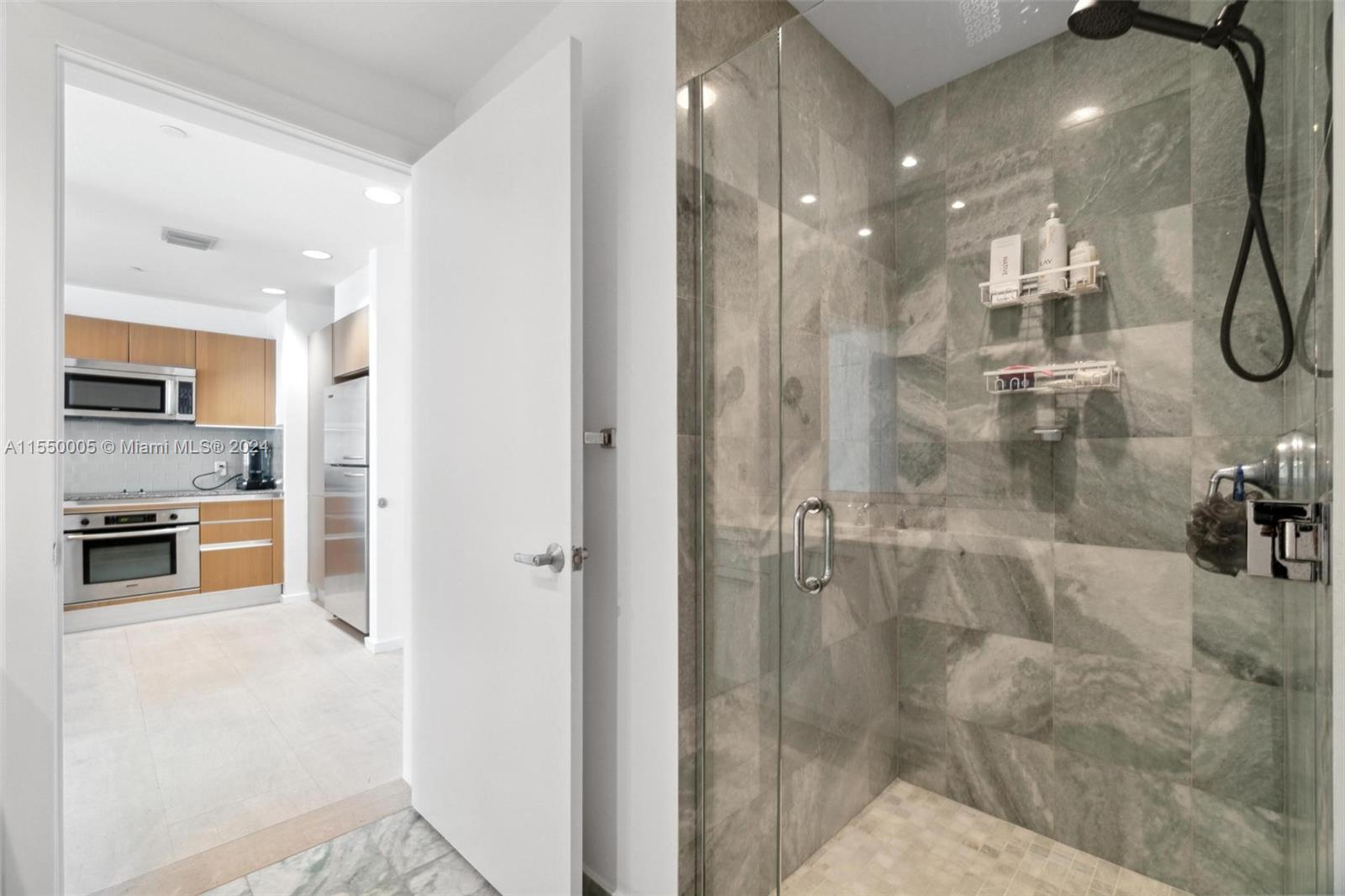 1050 Brickell Avenue, Unit 2422 Miami, FL 33131 - Photo 14 of 21 a bathroom with a shower and a sink