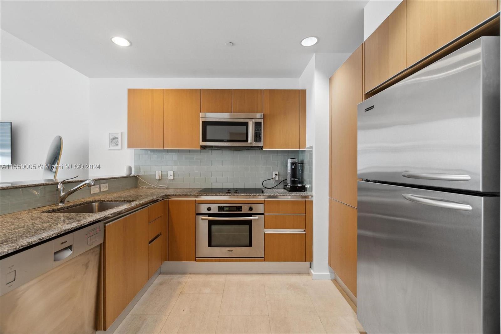1050 Brickell Avenue, Unit 2422 Miami, FL 33131 - Photo 4 of 21 a kitchen with a sink stove and refrigerator