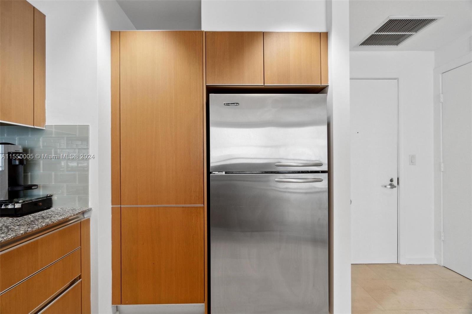 1050 Brickell Avenue, Unit 2422 Miami, FL 33131 - Photo 5 of 21 a refrigerator freezer sitting in a kitchen