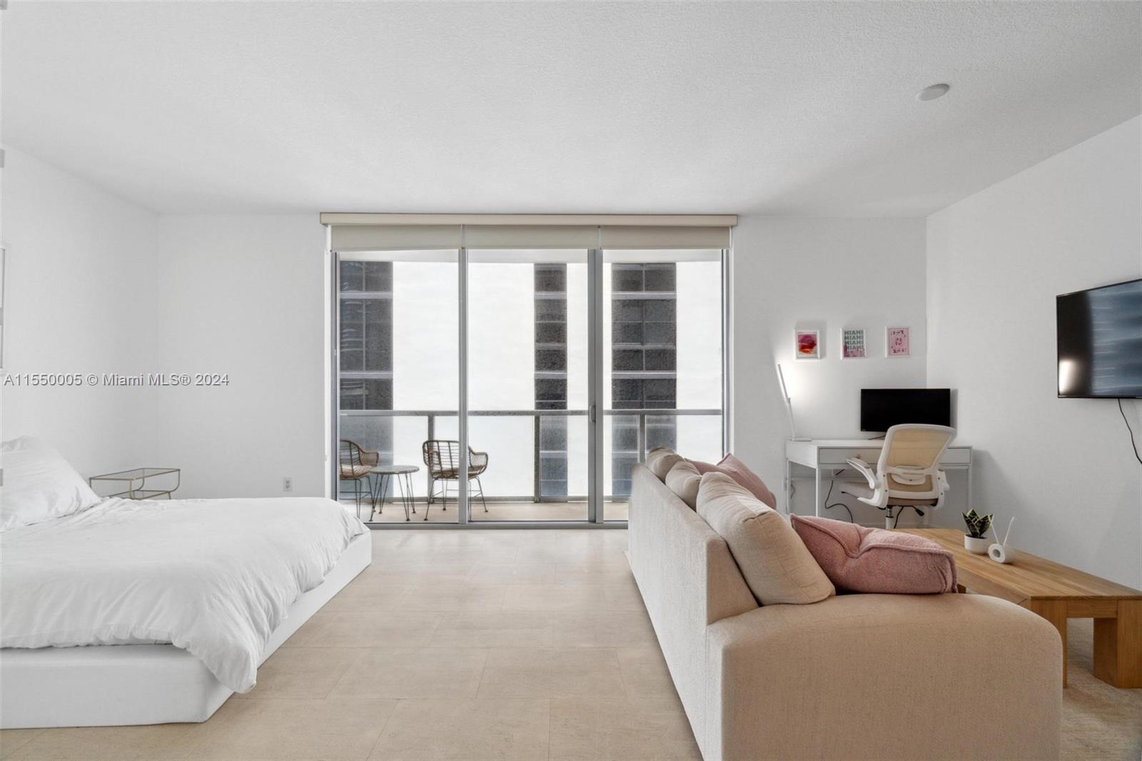 1050 Brickell Avenue, Unit 2422 Miami, FL 33131 - Photo 7 of 21 a living room with furniture and a large window