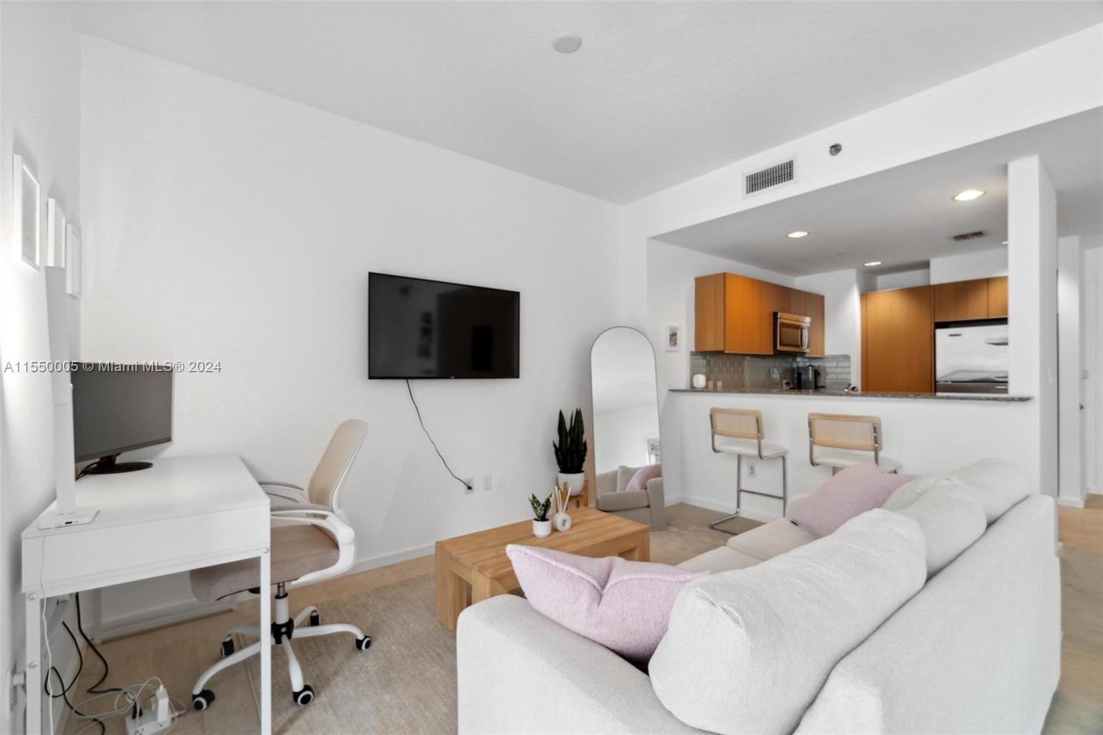 1050 Brickell Avenue, Unit 2422 Miami, FL 33131 - Photo 8 of 21 a living room with furniture and a flat screen tv