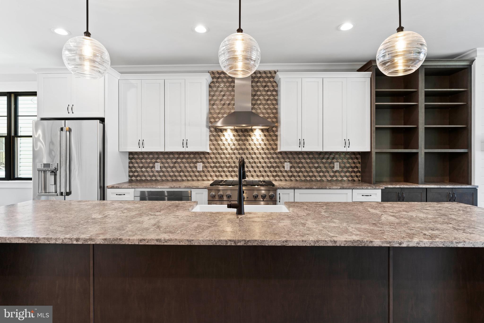 207 Maple Avenue Hershey, PA 17033 - Photo 15 of 79 a kitchen with kitchen island granite countertop a sink cabinets a window and stainless steel appliances