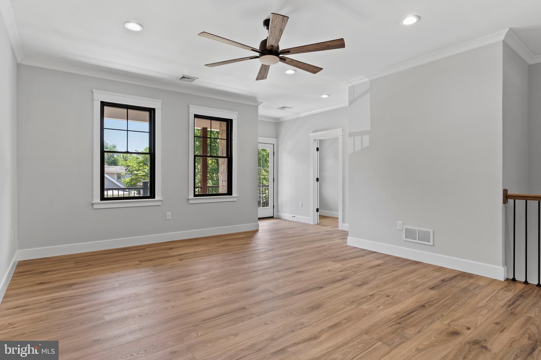 207 Maple Avenue Hershey, PA 17033 - Photo 20 of 79 an empty room with wooden floor chandelier fan and windows