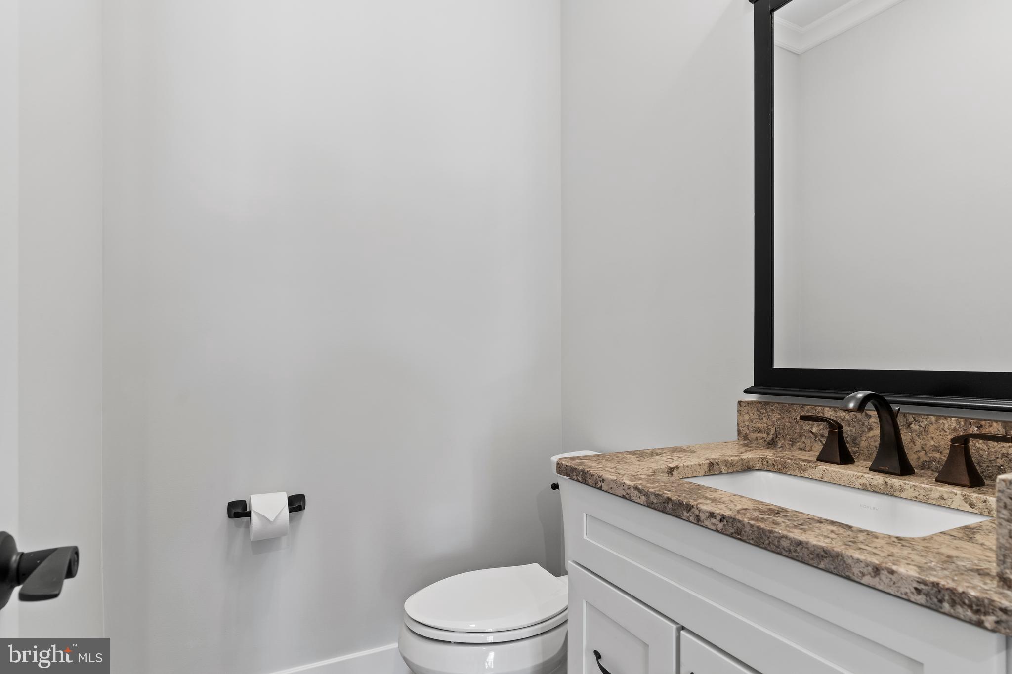 207 Maple Avenue Hershey, PA 17033 - Photo 31 of 79 a bathroom with a granite countertop sink toilet and mirror