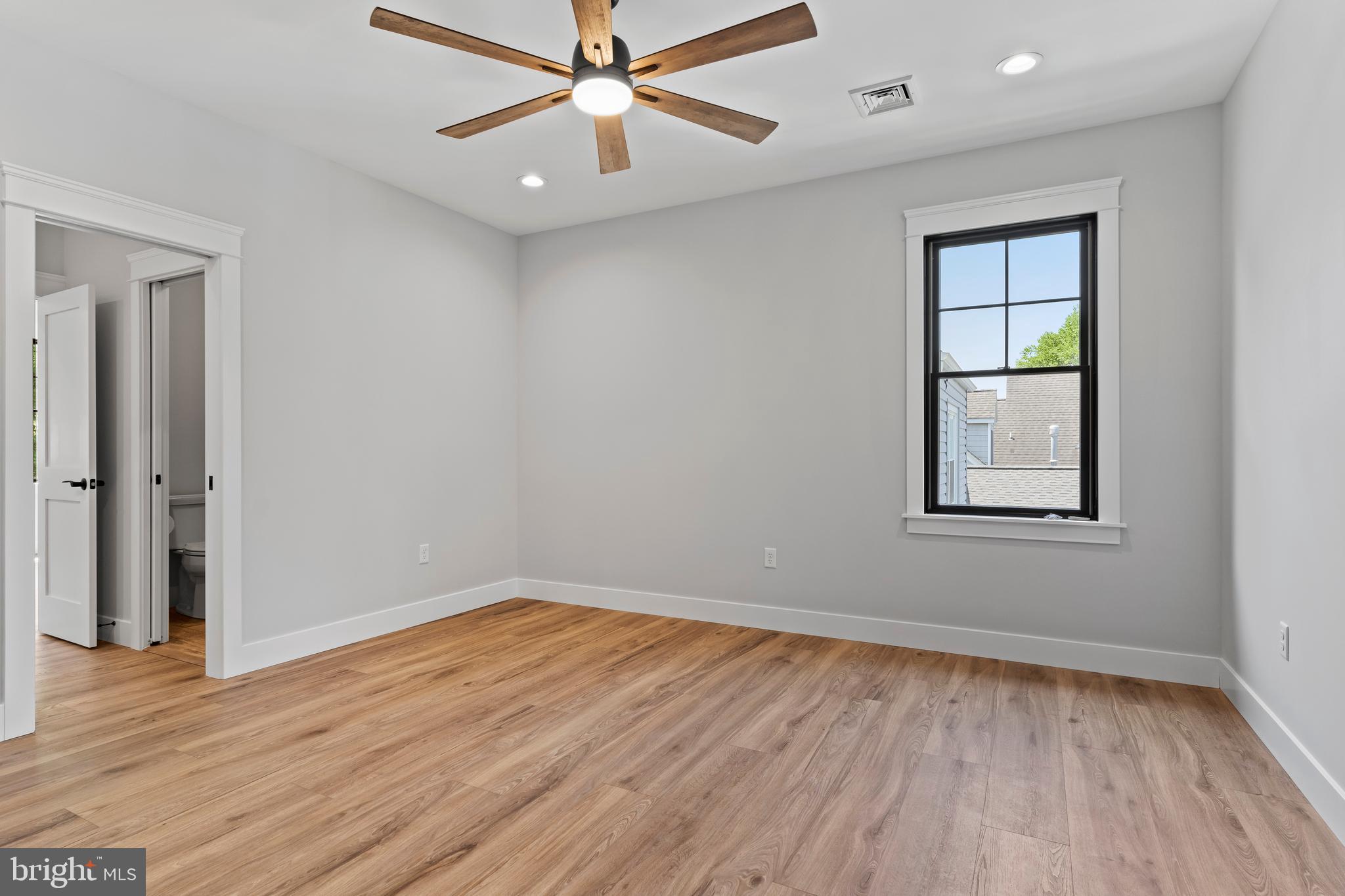 207 Maple Avenue Hershey, PA 17033 - Photo 60 of 79 an empty room with wooden floor chandelier fan and windows