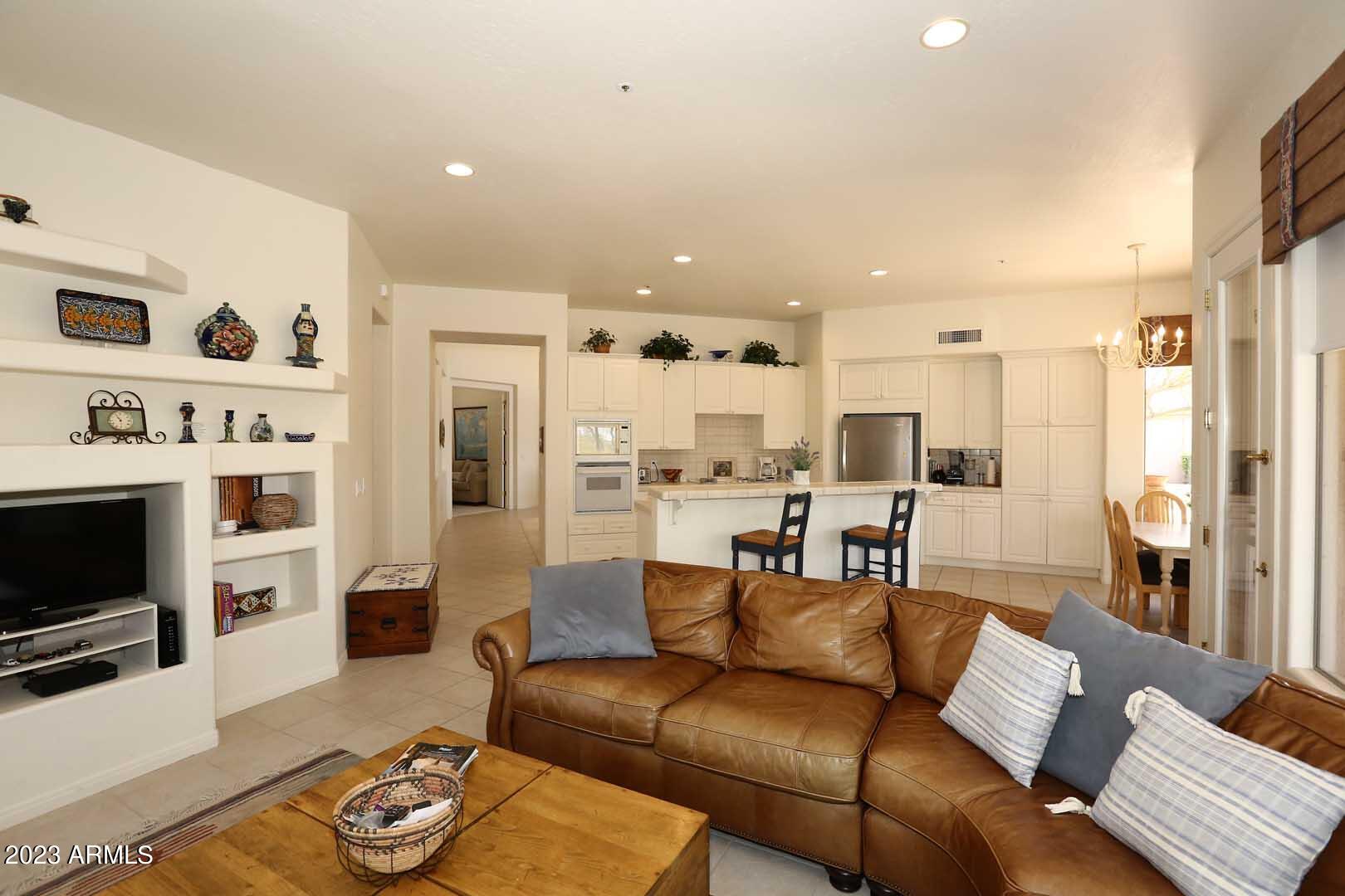 6335 East Marioca Circle Scottsdale, AZ 85266 - Photo 15 of 66 a large living room with stainless steel appliances furniture and a view of kitchen