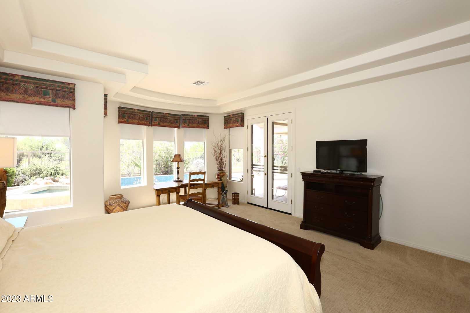 6335 East Marioca Circle Scottsdale, AZ 85266 - Photo 19 of 66 a bed room with a bed and a television