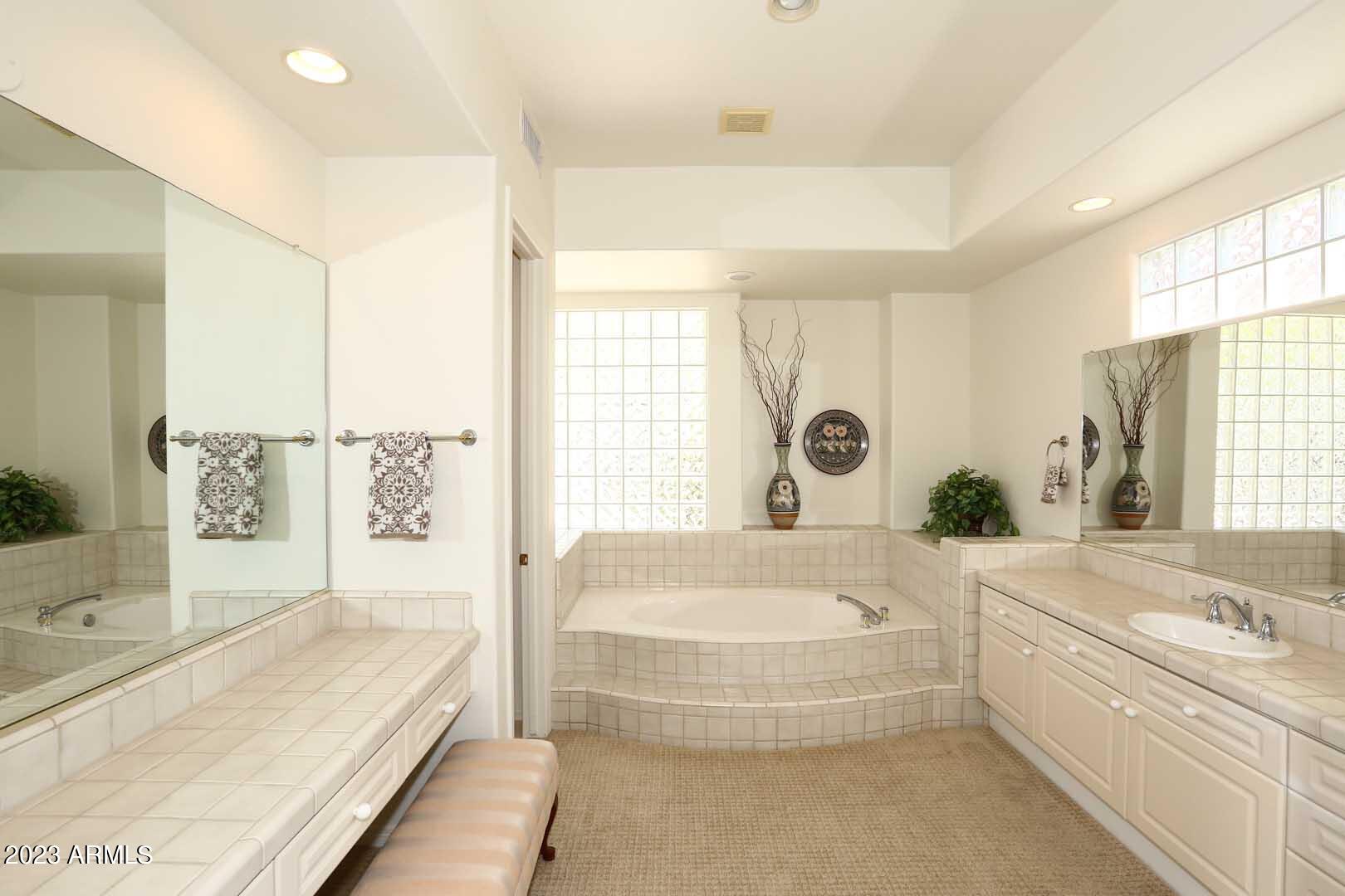 6335 East Marioca Circle Scottsdale, AZ 85266 - Photo 21 of 66 a spacious bathroom with a tub sink and mirror