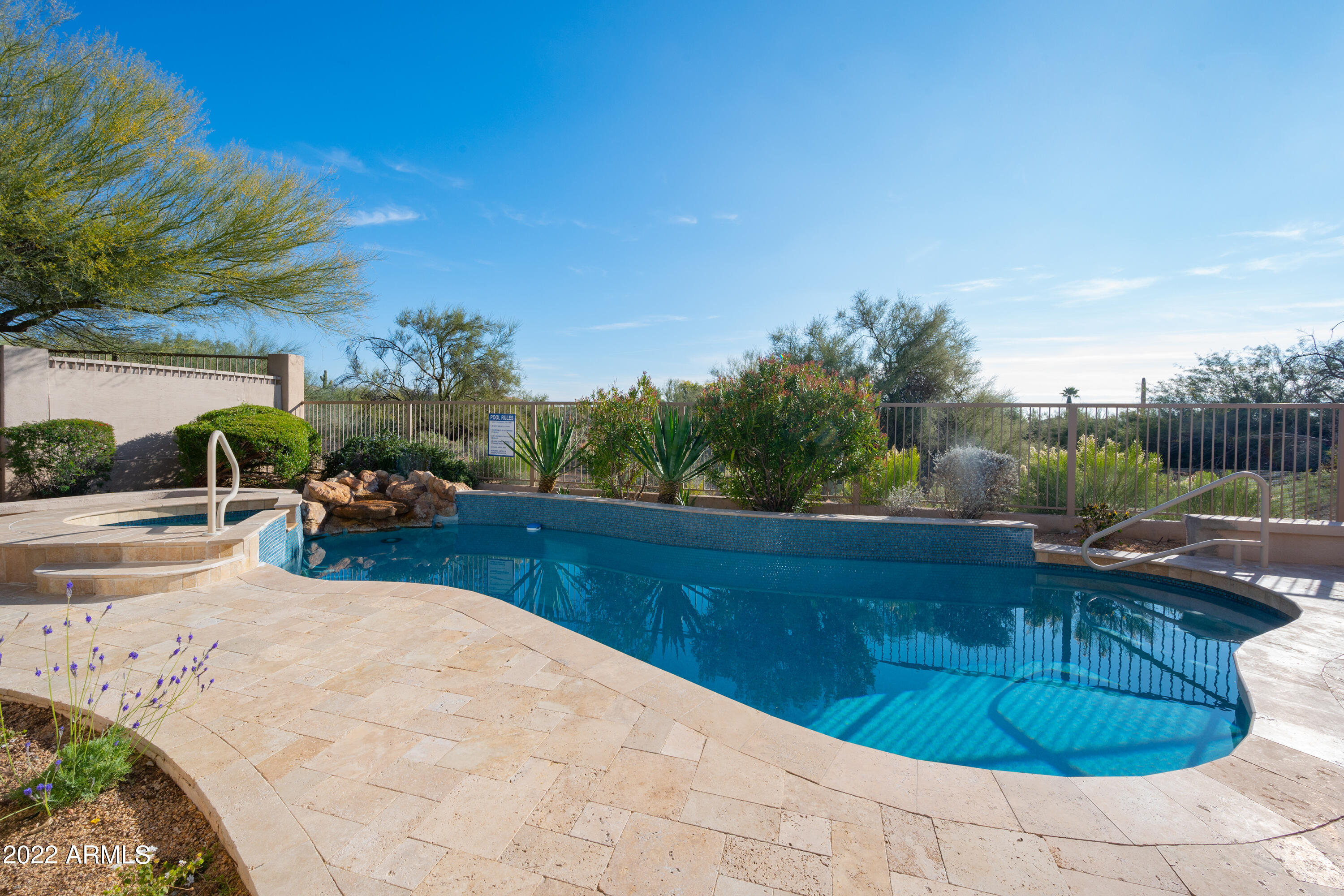 6335 East Marioca Circle Scottsdale, AZ 85266 - Photo 33 of 66 a view of a swimming pool with a lounge chair and a fire pit