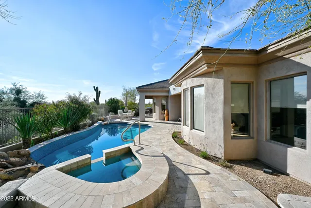 a view of swimming pool with outdoor seating and yard in back