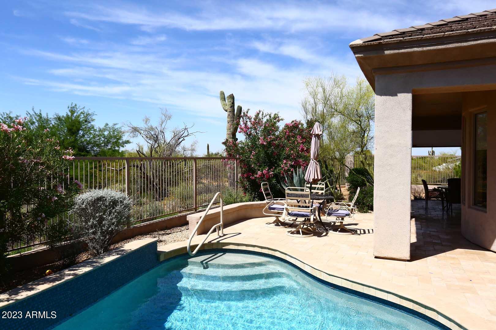 6335 East Marioca Circle Scottsdale, AZ 85266 - Photo 40 of 66 a view of a swimming pool with a patio