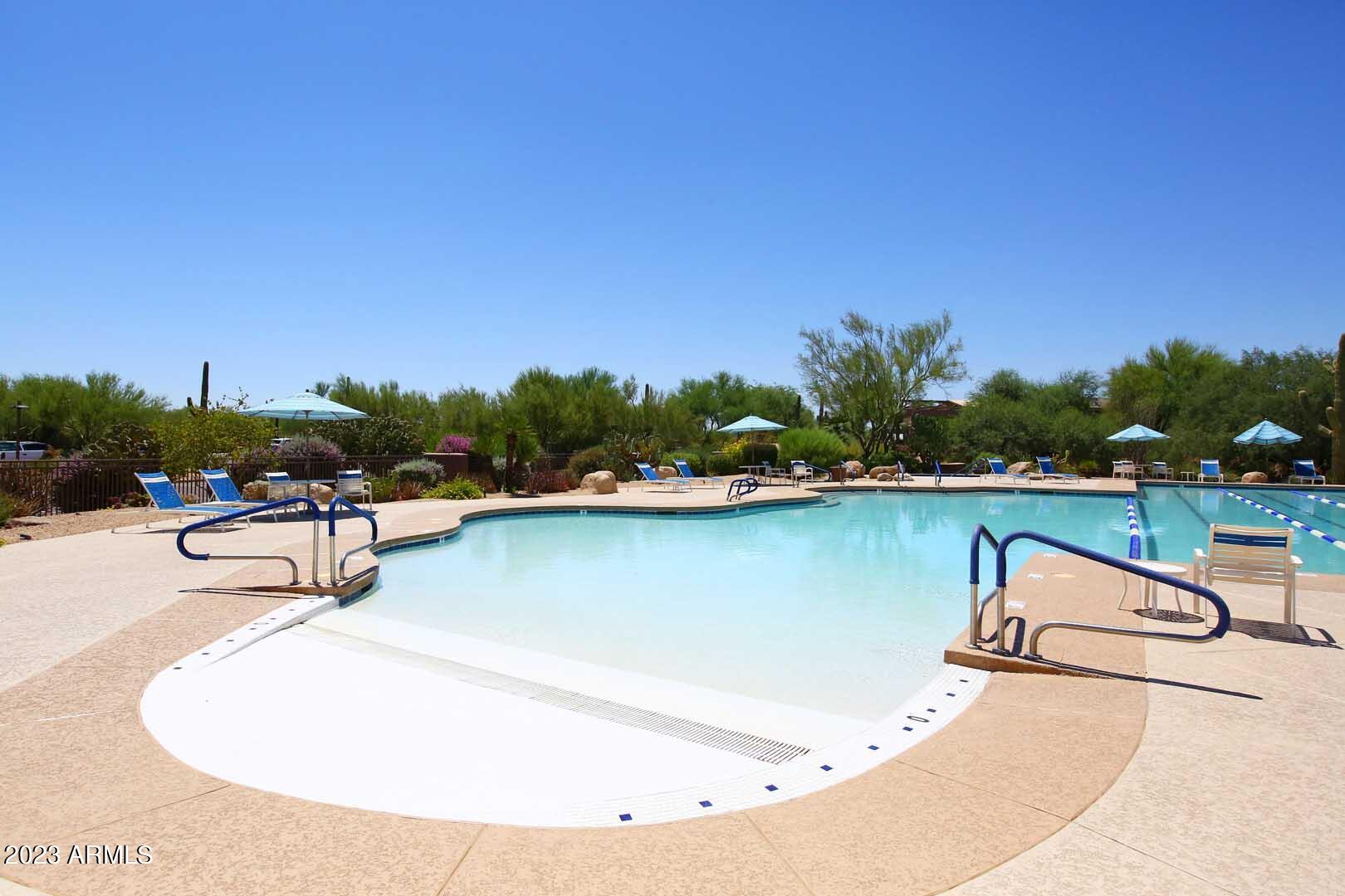6335 East Marioca Circle Scottsdale, AZ 85266 - Photo 50 of 66 a view of swimming pool with outdoor seating and yard in back