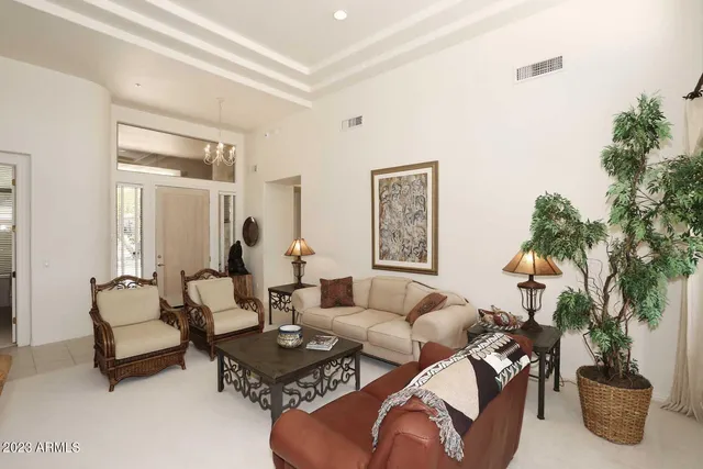 a living room with furniture potted plant and a window