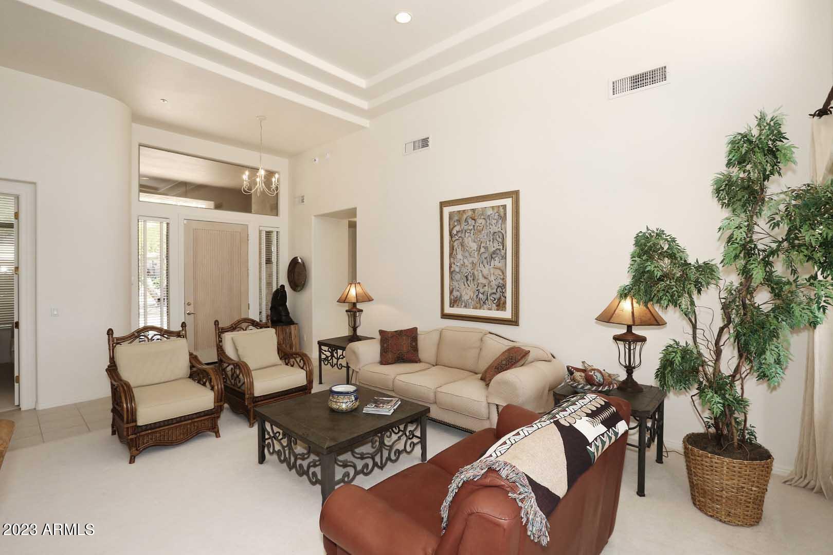6335 East Marioca Circle Scottsdale, AZ 85266 - Photo 5 of 66 a living room with furniture potted plant and a window