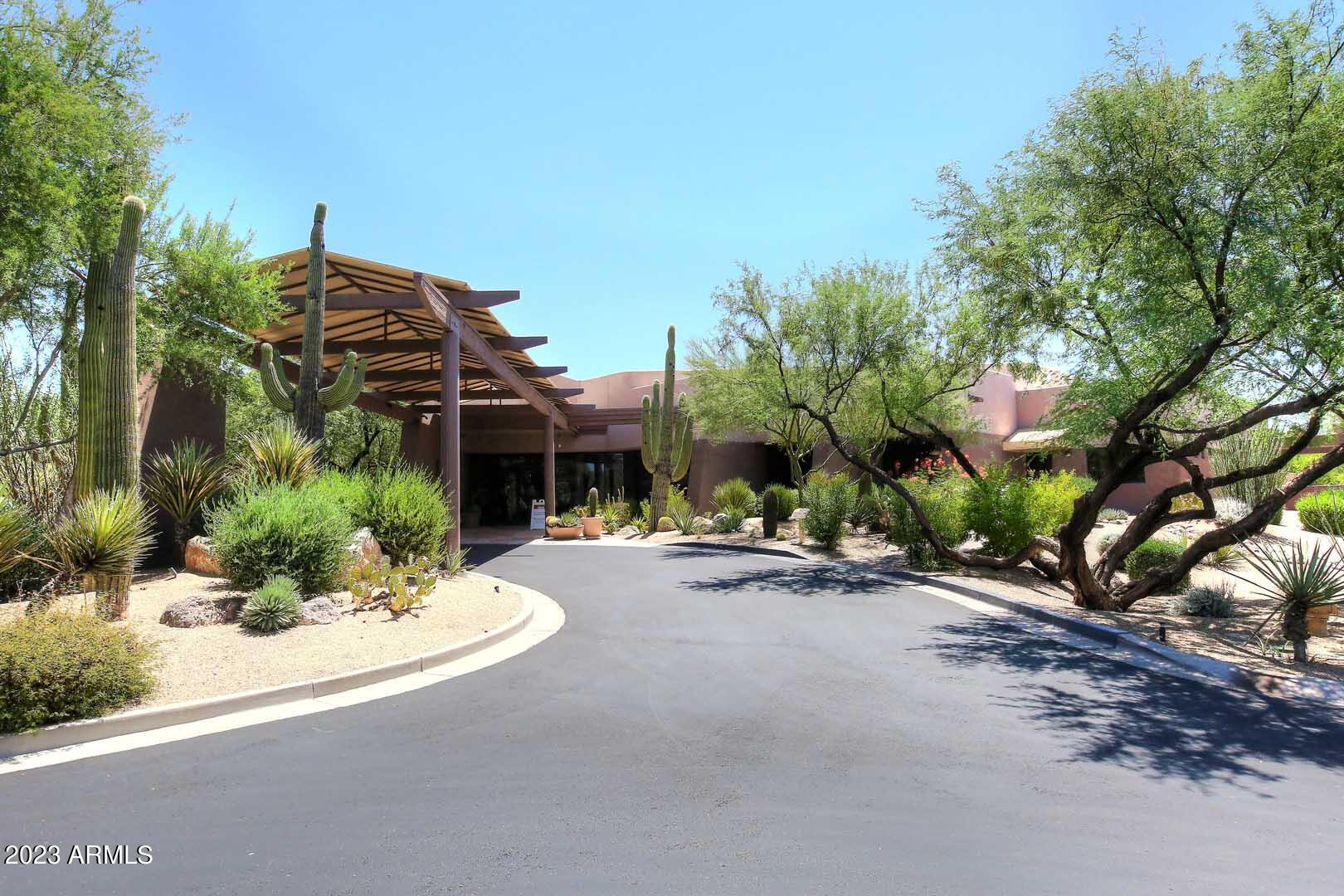 6335 East Marioca Circle Scottsdale, AZ 85266 - Photo 54 of 66 a view of a house with potted plants and a large tree