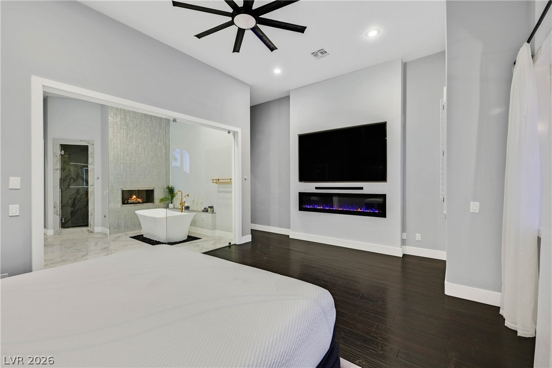 6 Rue Du Ville Henderson, NV 89011 - Photo 57 of 99 This primary bedroom suite seamlessly connects to a luxurious bathroom with a freestanding tub.