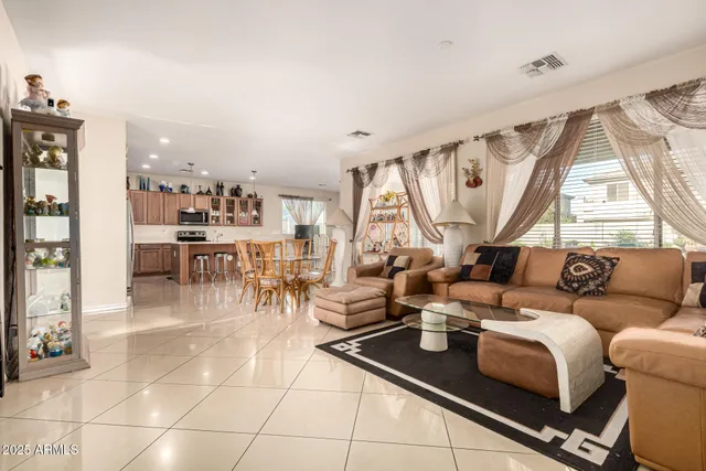 a living room with lots of furniture and a large window