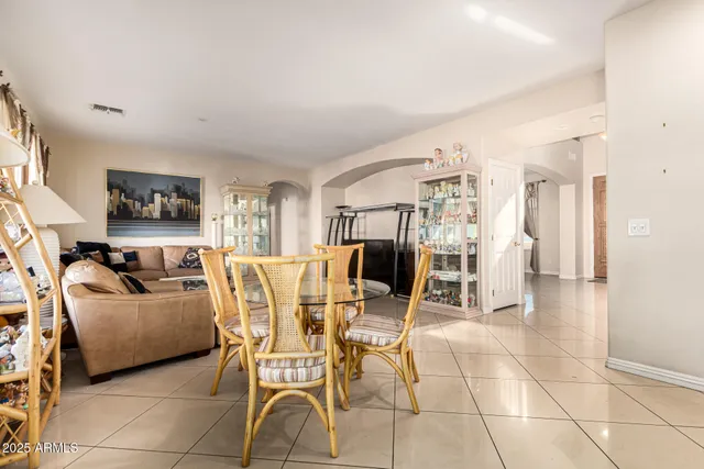 a living room with furniture a dining table and chairs