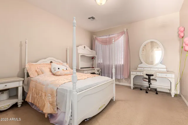 a bed room with a bed and a chair