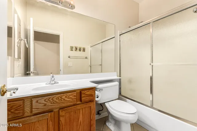 a bathroom with a sink toilet vanity and shower