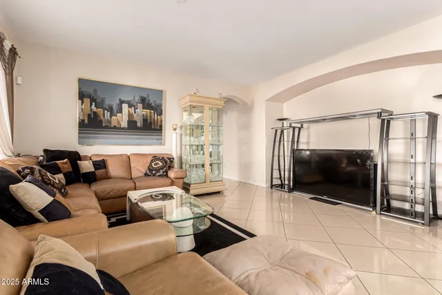 a living room with furniture and a glass door