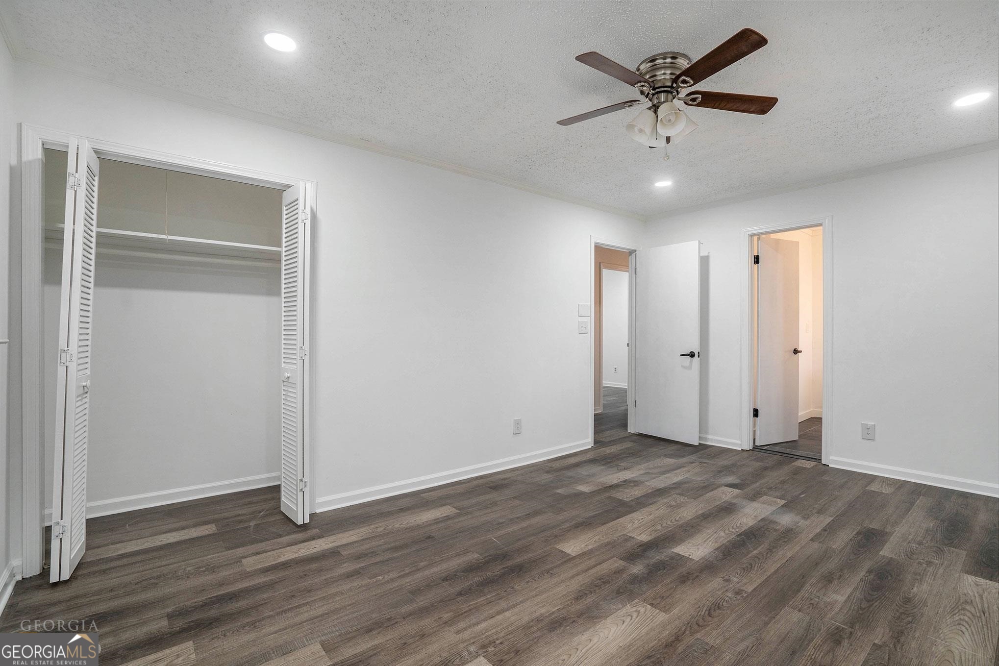 3343 Spring Meadow Court Tucker, GA 30084 - Photo 20 of 24 an empty room with wooden floor and ceiling fan