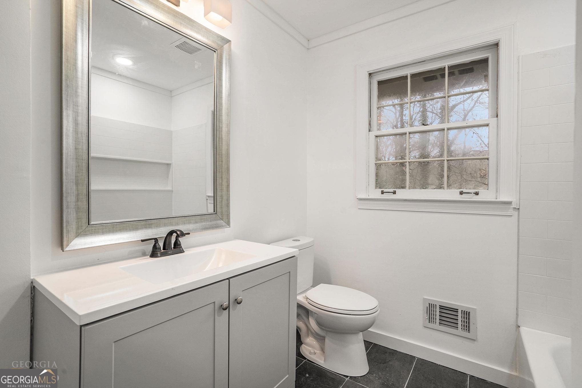 3343 Spring Meadow Court Tucker, GA 30084 - Photo 21 of 24 a bathroom with a toilet sink and mirror