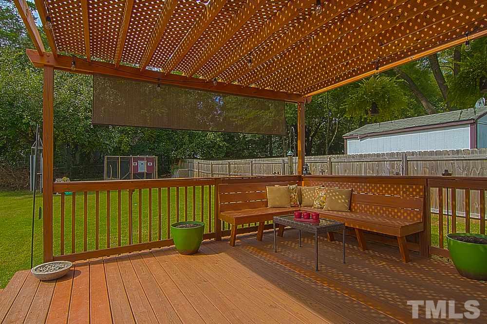 2616 Newbold Street Raleigh, NC 27603 - Photo 14 of 17 a view of a patio with table and chairs with wooden floor and fence