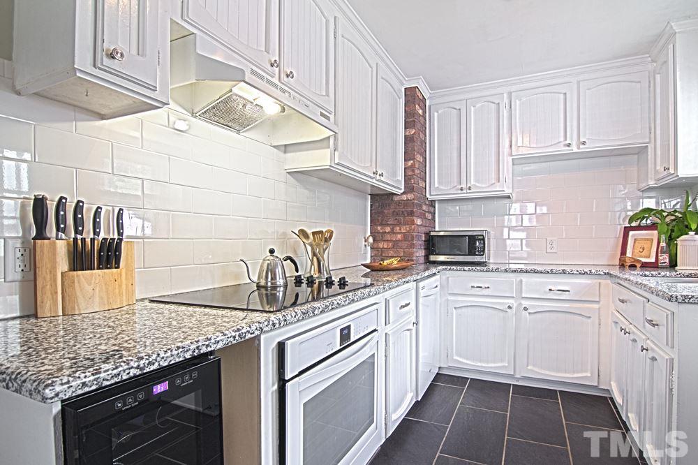 2616 Newbold Street Raleigh, NC 27603 - Photo 8 of 17 a kitchen with a sink dishwasher and cabinets