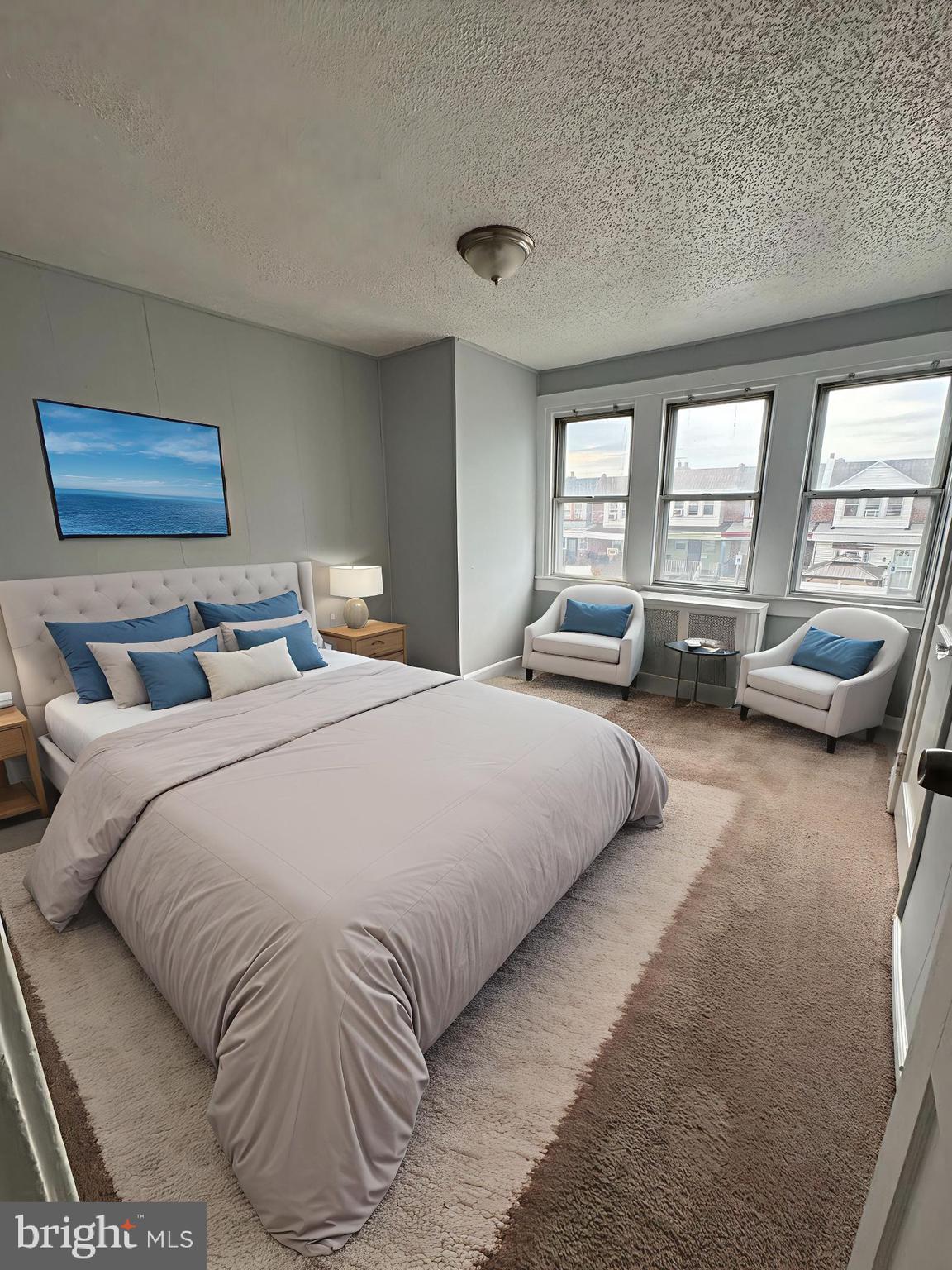 841 Bridge Street Philadelphia, PA 19124 - Photo 2 of 11 a bedroom with a bed and a couch