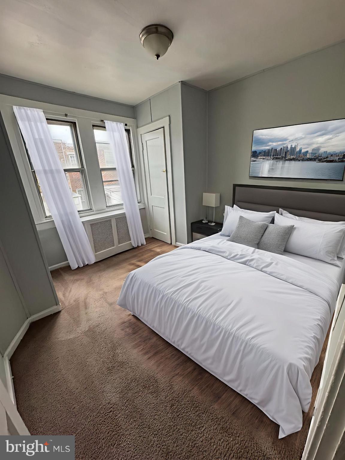 841 Bridge Street Philadelphia, PA 19124 - Photo 3 of 11 a bedroom with a large bed and a large window