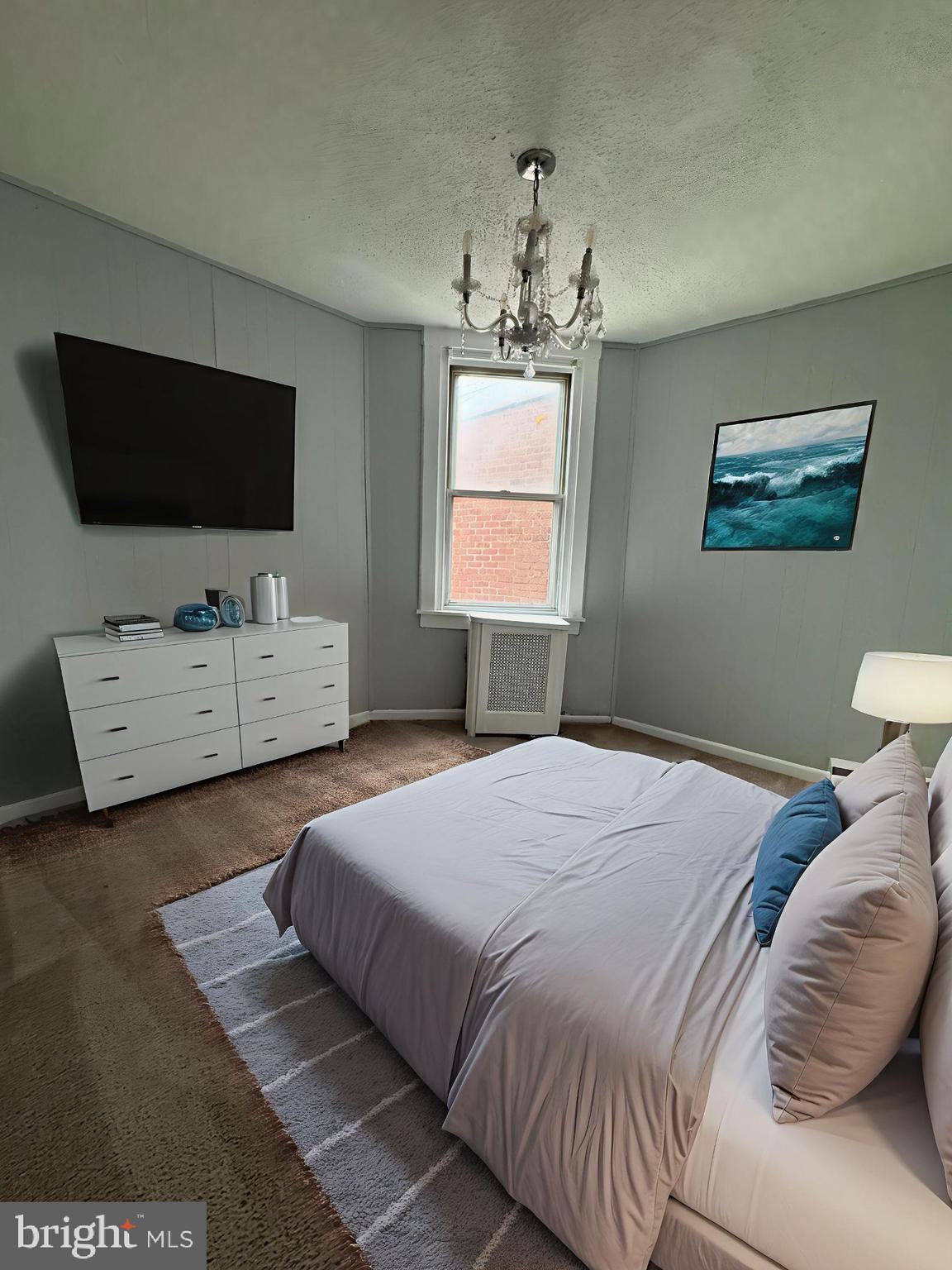 841 Bridge Street Philadelphia, PA 19124 - Photo 4 of 11 a bedroom with a bed and a flat screen tv