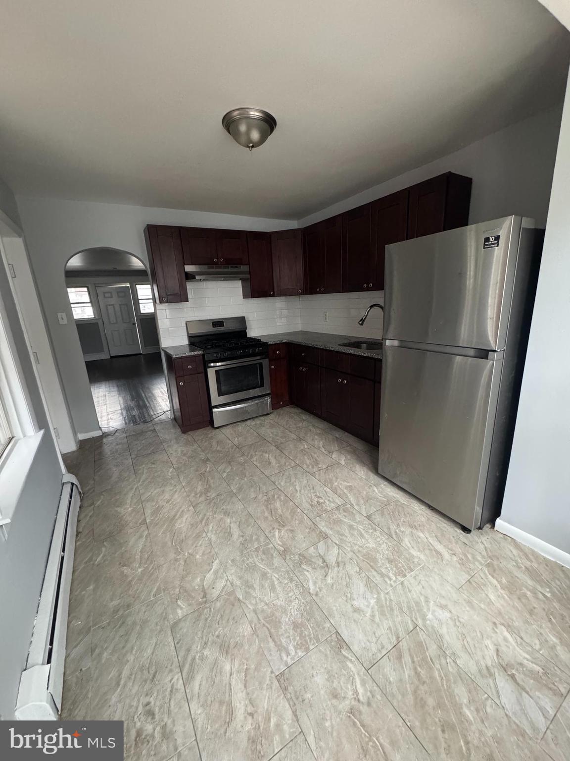 841 Bridge Street Philadelphia, PA 19124 - Photo 5 of 11 a kitchen with refrigerator and window