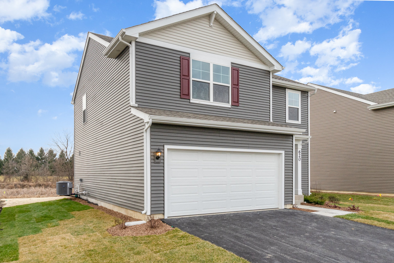 620 Ensign Place Hebron, IN 46341 - Photo 2 of 19 a front view of a house with a yard and garage
