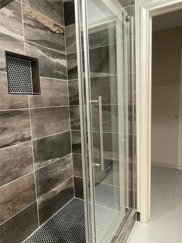 a bathroom with a glass shower door