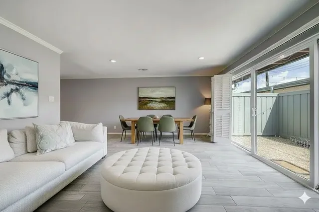 a living room with furniture and a floor to ceiling window